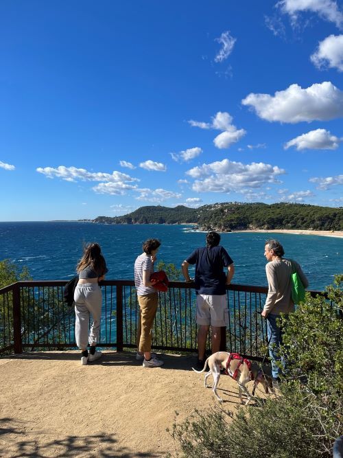 Familia de espaldas en uno de los miradores del camino de ronda de Lloret a Fenals
